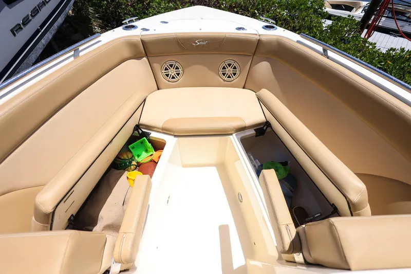 Slide: The Image of 2020 Scout 235 Dorado boat interior with tan seating and storage compartments. - 27