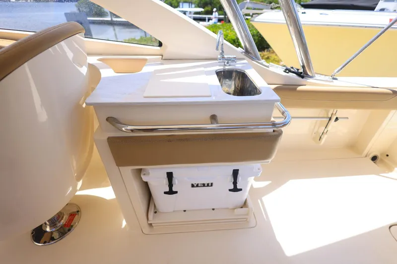 Slide: The Image of 2020 Scout 235 Dorado boat interior with sink and Yeti cooler. - 10