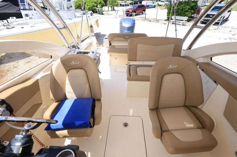 Slide: The Image of 2020 Scout 235 Dorado boat interior with tan seating and steering wheel. - 25