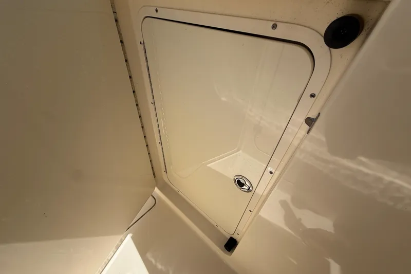 Slide: The Image of Storage compartment on a 2020 Scout 235 Dorado boat, featuring a secure latch. - 34