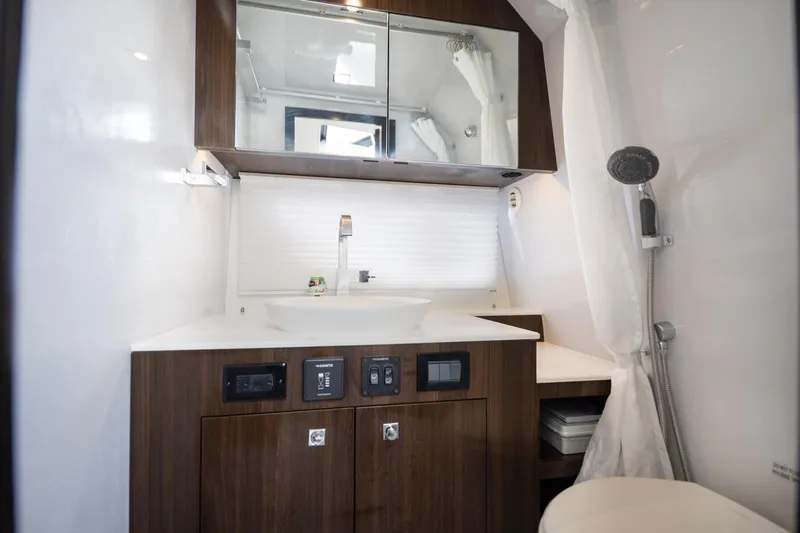 Slide: The Image of Luxurious bathroom in 2022 New Cruiser Yachts GLS 38 with modern fixtures and wood accents. - 47