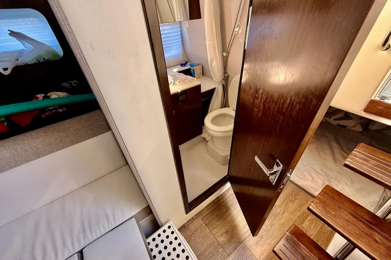 Slide: The Image of Interior of 2022 New Cruiser Yachts GLS 38, featuring a compact bathroom and cozy cabin space. - 43