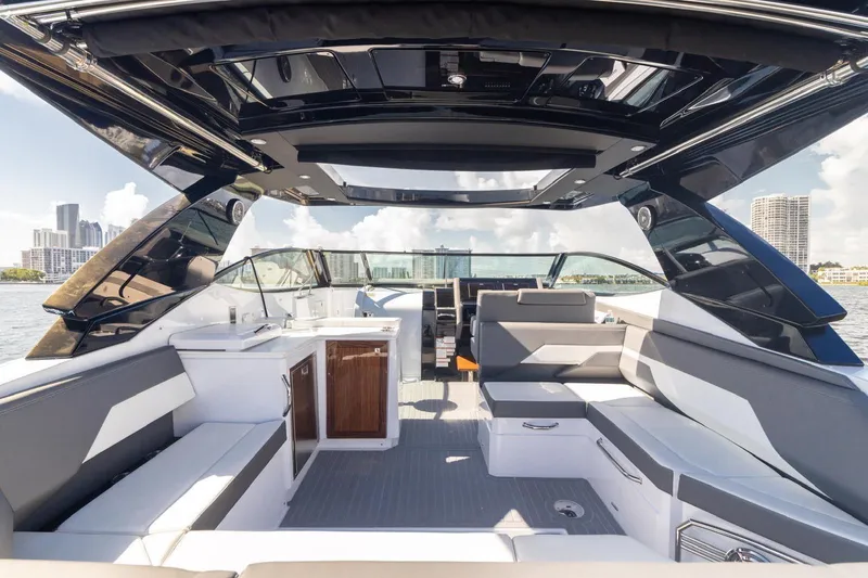 Slide: The Image of Luxurious 2022 New Cruiser Yachts GLS 38 interior with modern seating and city skyline view. - 22