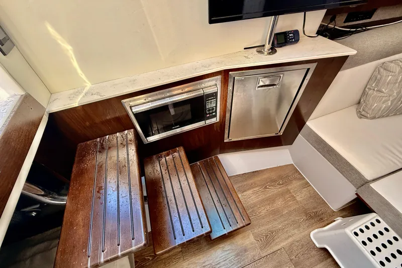 Slide: The Image of Interior of 2022 New Cruiser Yachts GLS 38 with microwave and wooden steps. - 42