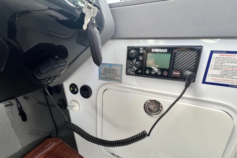 Slide: The Image of 2022 New Cruiser Yachts GLS 38 dashboard with Simrad marine radio and controls. - 31