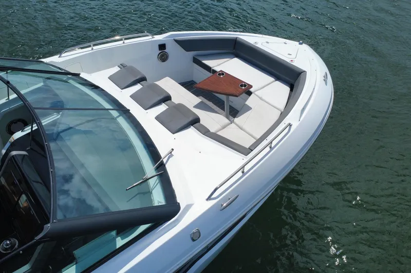 Slide: The Image of 2022 New Cruiser Yachts GLS 38, featuring spacious deck seating and table on calm waters. - 14