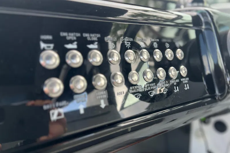 Slide: The Image of Control panel of 2022 New Cruiser Yachts GLS 38 with labeled buttons and switches. - 26
