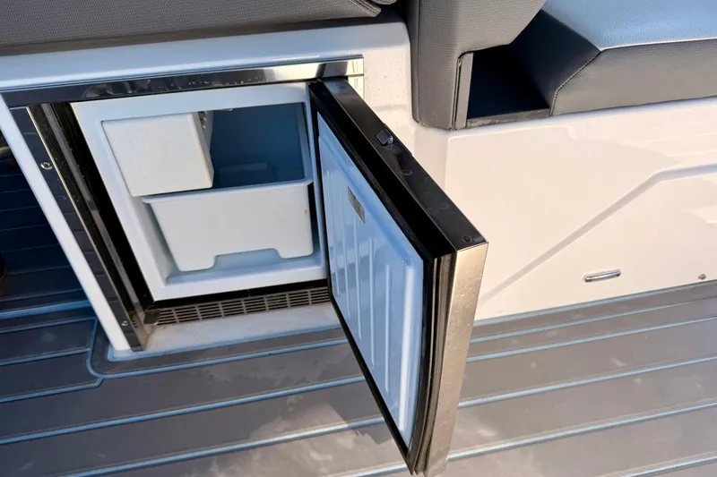 Slide: The Image of Open refrigerator on 2022 New Cruiser Yachts GLS 38, showcasing interior storage space. - 60