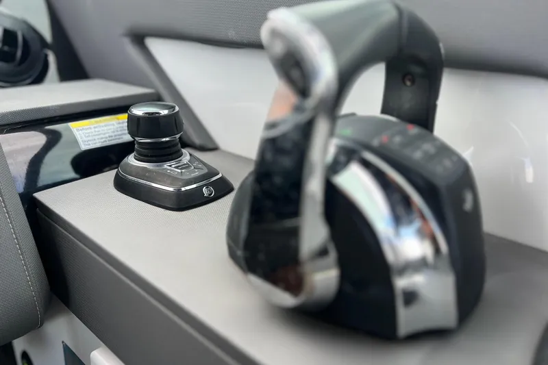 Slide: The Image of Close-up of 2022 New Cruiser Yachts GLS 38 control panel with joystick and throttle. - 29