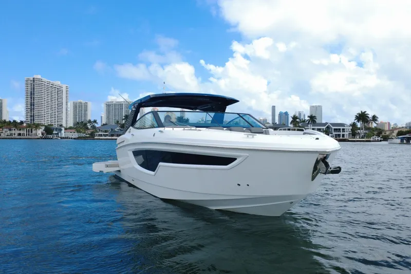 The Image of 2022 New Cruiser Yachts GLS 38 on water, city skyline in background. - 0