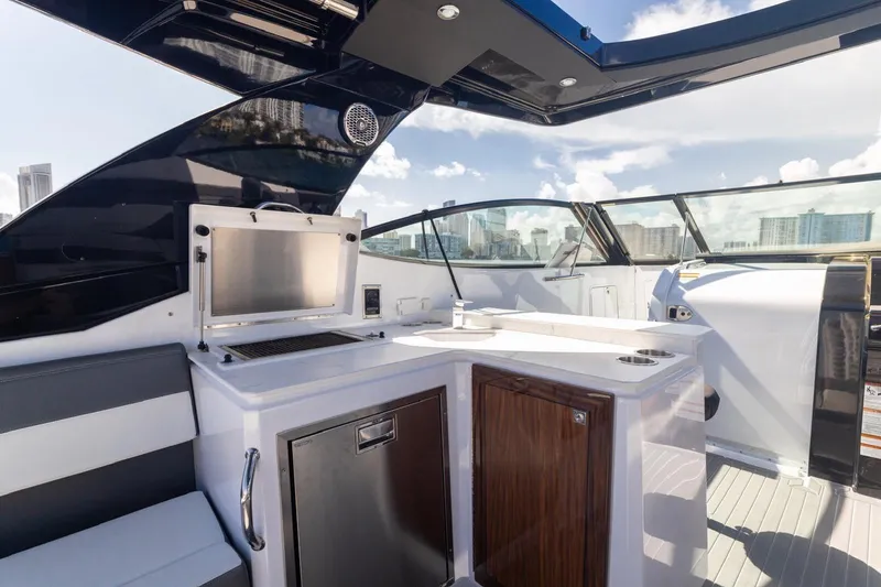 Slide: The Image of Luxurious 2022 New Cruiser Yachts GLS 38 interior with sleek kitchen and city skyline view. - 24