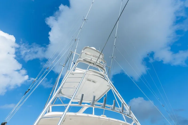 Slide: The Image of Viking 52 Sport Tower 2021 against a bright blue sky with clouds. - 35