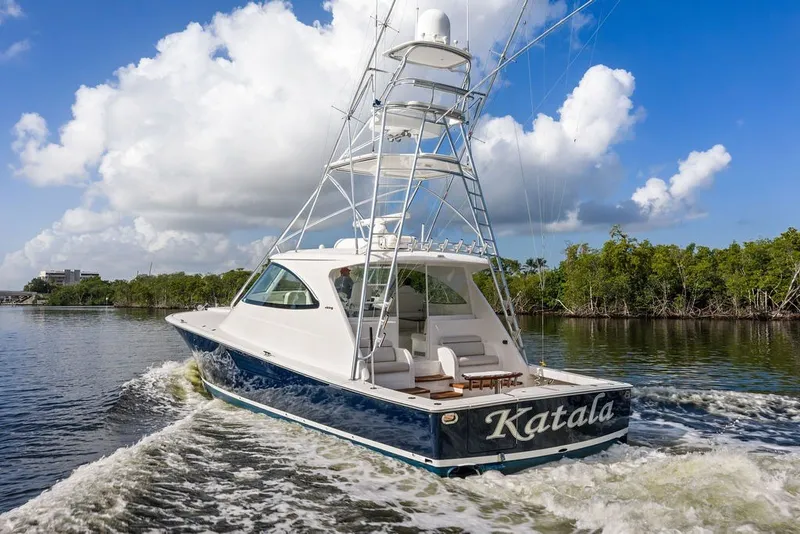 Slide: The Image of 2021 Viking 52 Sport Tower yacht cruising on a scenic waterway. - 3
