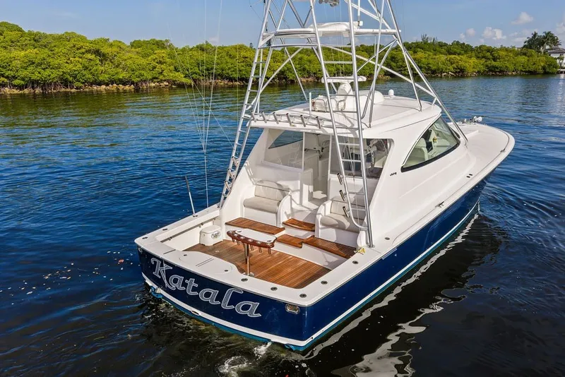 Slide: The Image of 2021 Viking 52 Sport Tower yacht on calm water, featuring sleek design and spacious deck. - 17