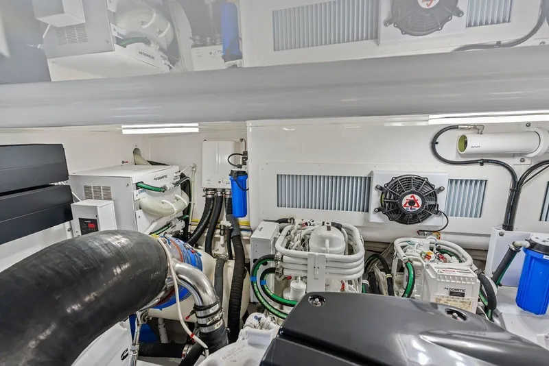 Slide: The Image of Engine room of 2021 Viking 52 Sport Tower, showcasing advanced marine equipment and systems. - 74