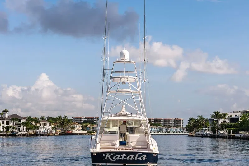 Slide: The Image of 2021 Viking 52 Sport Tower yacht on a scenic waterway under a blue sky. - 18
