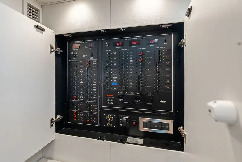 Slide: The Image of Electrical panel inside 2021 Viking 52 Sport Tower yacht, showcasing control switches and indicators. - 53