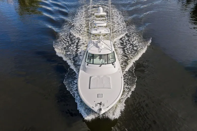 Slide: The Image of 2021 Viking 52 Sport Tower cruising on calm waters, aerial view. - 14