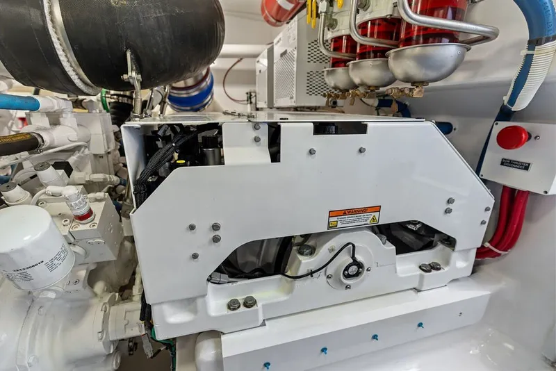 Slide: The Image of Engine room of a 2021 Viking 52 Sport Tower yacht, showcasing mechanical components. - 68