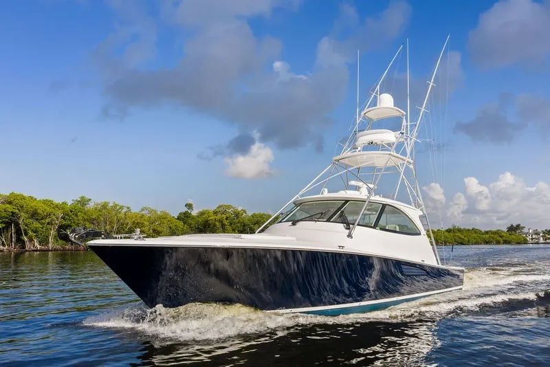 Slide: The Image of 2021 Viking 52 Sport Tower yacht cruising on a sunny day. - 8