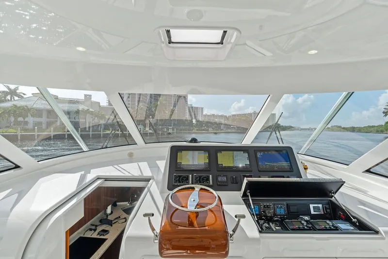 Slide: The Image of Interior view of 2021 Viking 52 Sport Tower yacht helm with navigation equipment. - 42