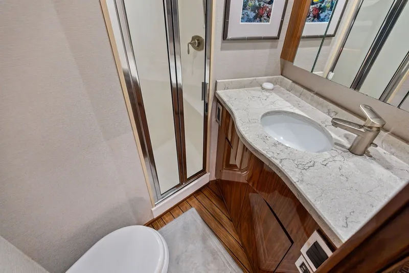 Slide: The Image of Luxurious bathroom in 2021 Viking 52 Sport Tower yacht with marble countertop and shower. - 62