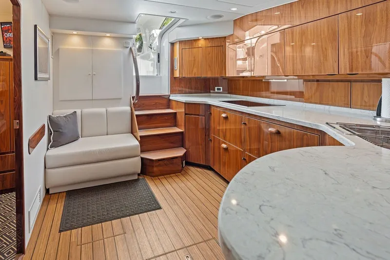 Slide: The Image of Luxurious interior of 2021 Viking 52 Sport Tower yacht with modern kitchen and seating area. - 47