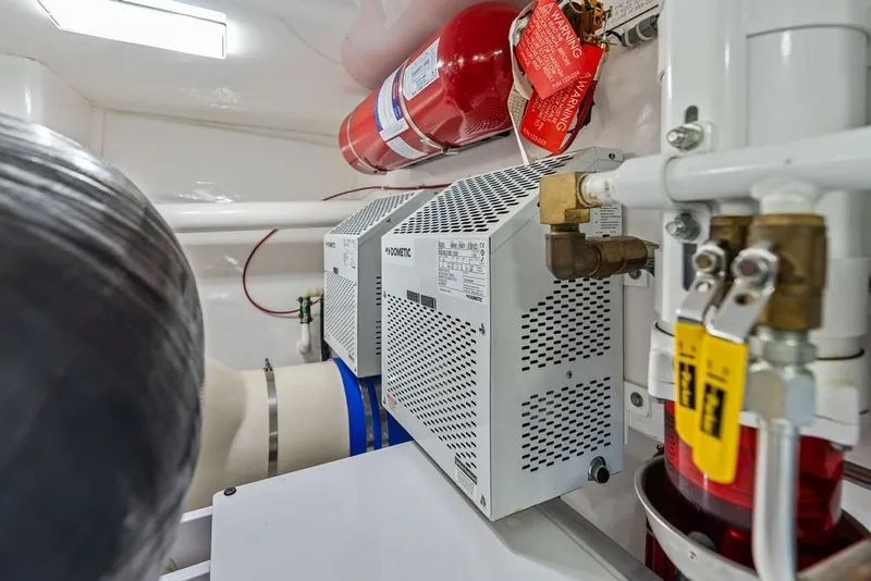 Slide: The Image of Engine room of 2021 Viking 52 Sport Tower with fire suppression system and mechanical components. - 72