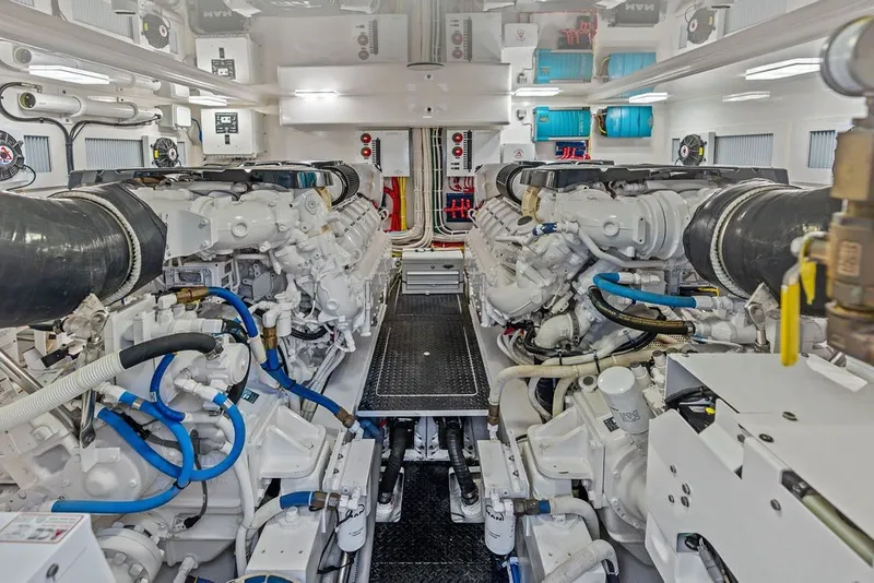 Slide: The Image of Engine room of a 2021 Viking 52 Sport Tower, showcasing dual engines and mechanical systems. - 64