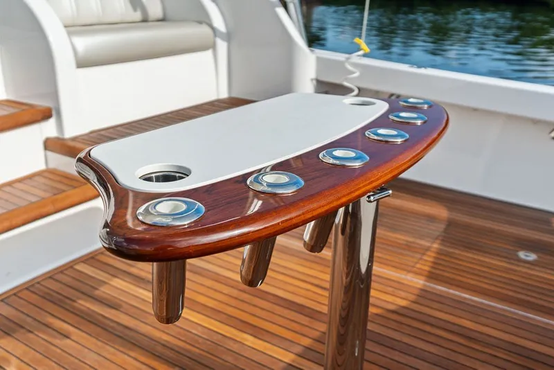 Slide: The Image of Fishing rod holders on a 2021 Viking 52 Sport Tower's polished wooden deck. - 29