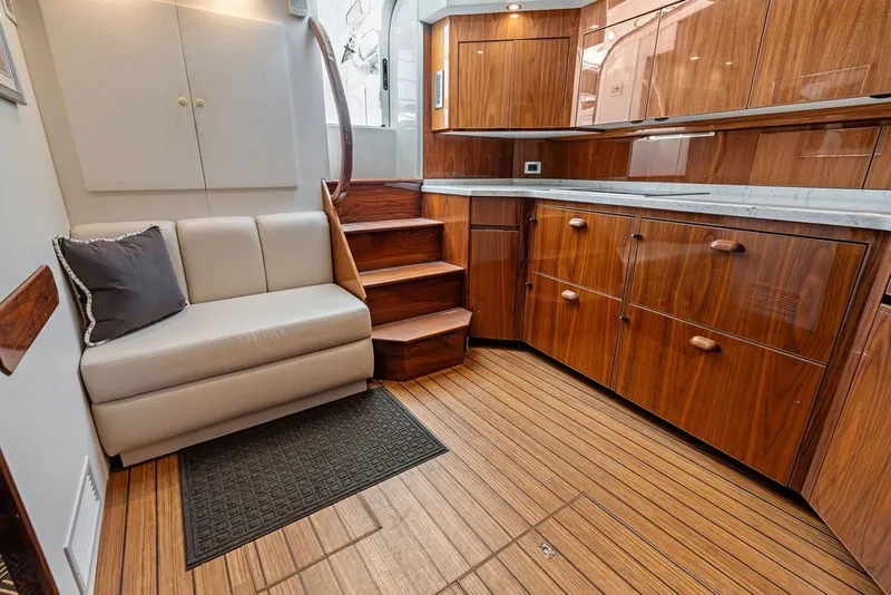 Slide: The Image of Luxurious interior of 2021 Viking 52 Sport Tower with wooden cabinetry and cozy seating. - 46