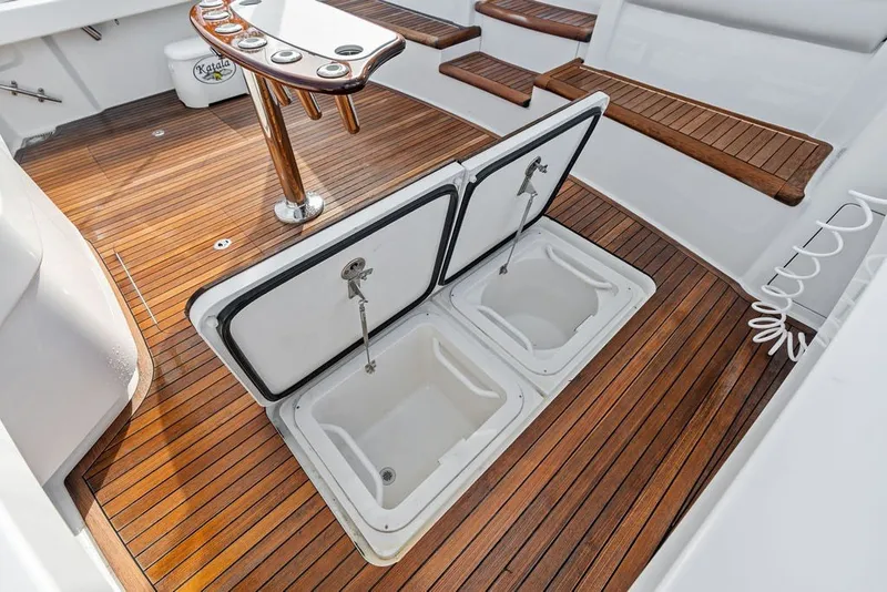 Slide: The Image of 2021 Viking 52 Sport Tower cockpit with teak flooring and open storage compartments. - 30