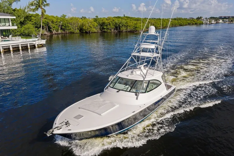 Slide: The Image of 2021 Viking 52 Sport Tower yacht cruising on a scenic waterway. - 9