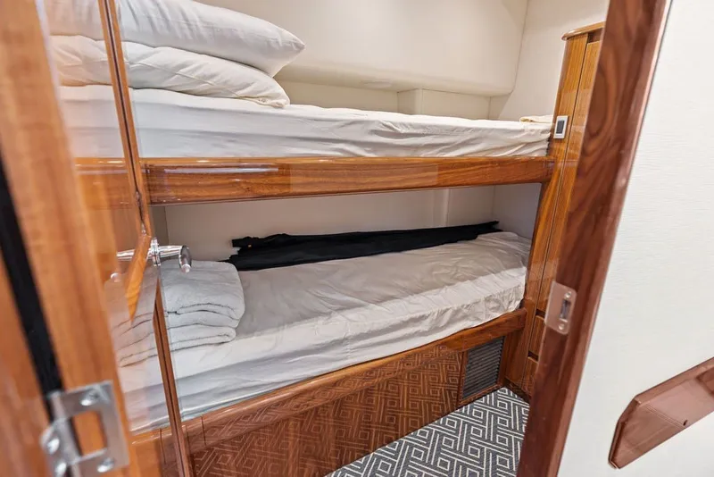 Slide: The Image of Bunk beds in 2021 Viking 52 Sport Tower yacht cabin with wooden finish. - 59