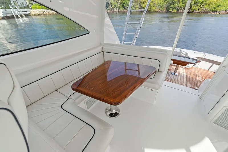 Slide: The Image of Luxurious seating area on 2021 Viking 52 Sport Tower yacht with wooden table. - 38