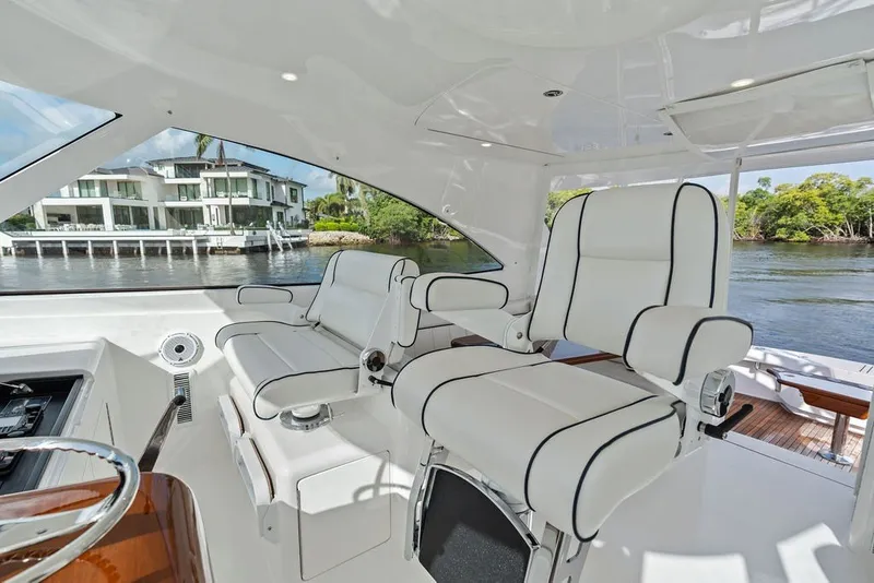 Slide: The Image of Interior of 2021 Viking 52 Sport Tower yacht with luxurious seating and waterfront view. - 40