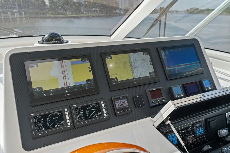 Slide: The Image of Cockpit of 2021 Viking 52 Sport Tower with advanced navigation displays and controls. - 43
