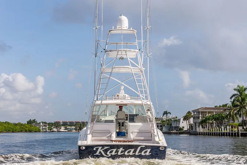 Slide: The Image of 2021 Viking 52 Sport Tower yacht cruising on a scenic waterway. - 25