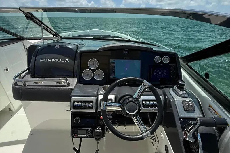 Slide: The Image of 2022 Formula 350 Crossover Bowrider dashboard with steering wheel and navigation controls. - 12