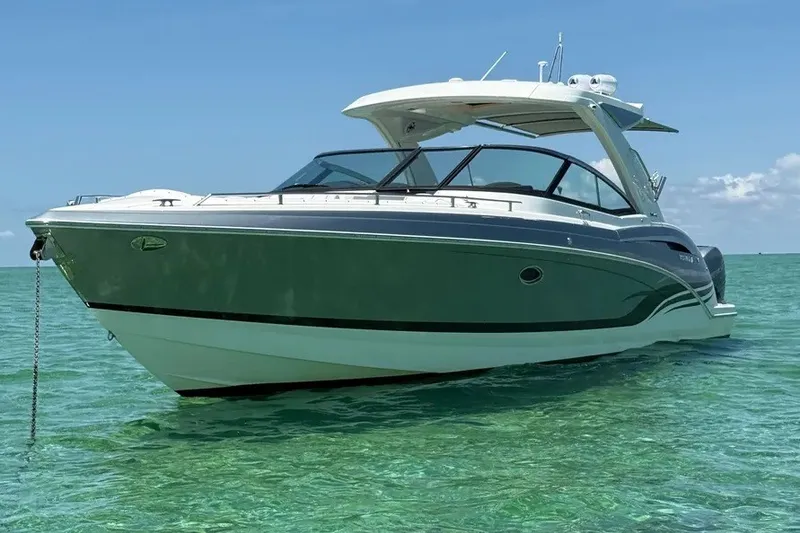 Slide: The Image of 2022 Formula 350 Crossover Bowrider on clear turquoise water under blue sky. - 1