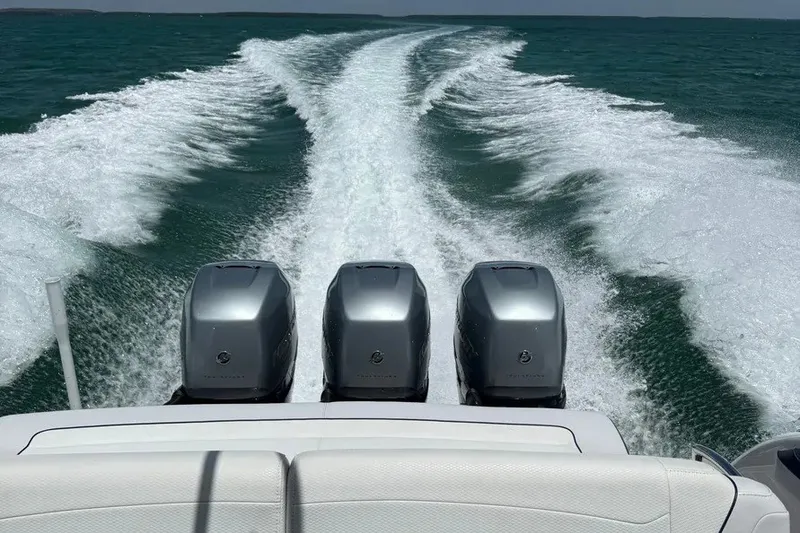 Slide: The Image of 2022 Formula 350 Crossover Bowrider with triple engines cruising on open water. - 19