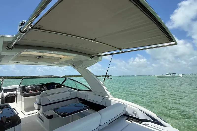 Slide: The Image of 2022 Formula 350 Crossover Bowrider on clear water under blue sky. - 7