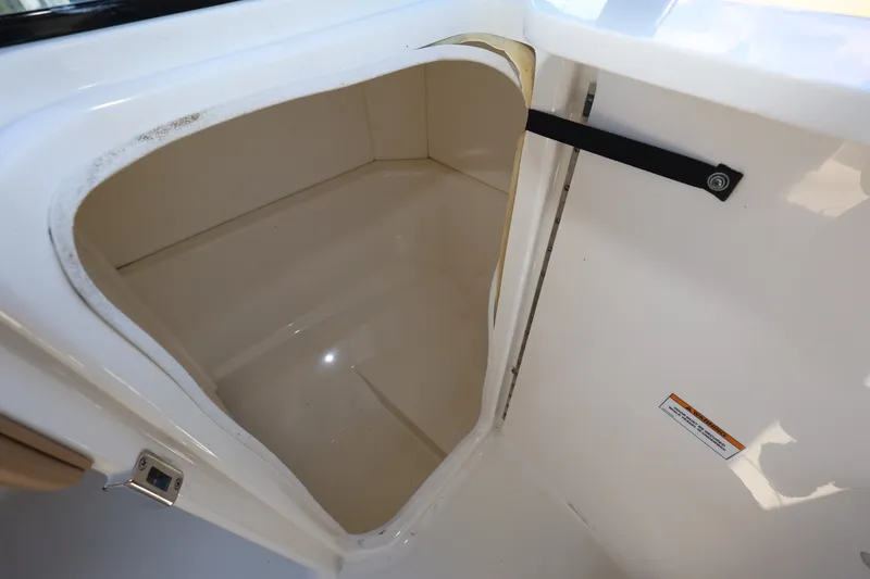 Slide: The Image of Storage compartment in 2023 Sea Ray SPX 230 Outboard boat, featuring sleek interior design. - 21