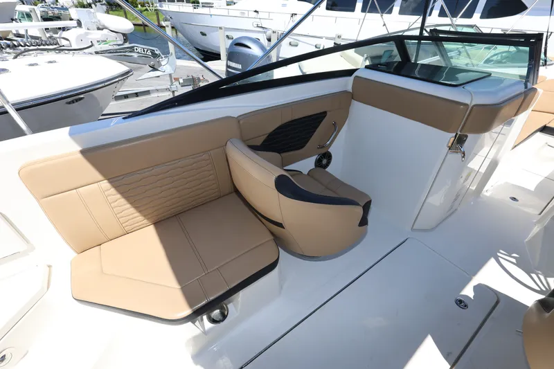 Slide: The Image of 2023 Sea Ray SPX 230 Outboard interior with tan seating and modern design. - 10