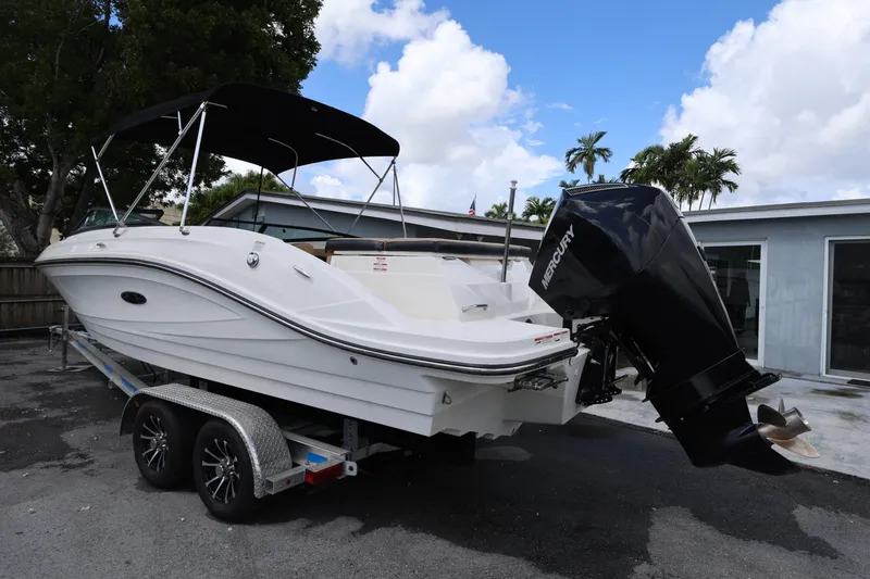 Slide: The Image of 2023 Sea Ray SPX 230 Outboard boat on trailer, parked outdoors. - 3