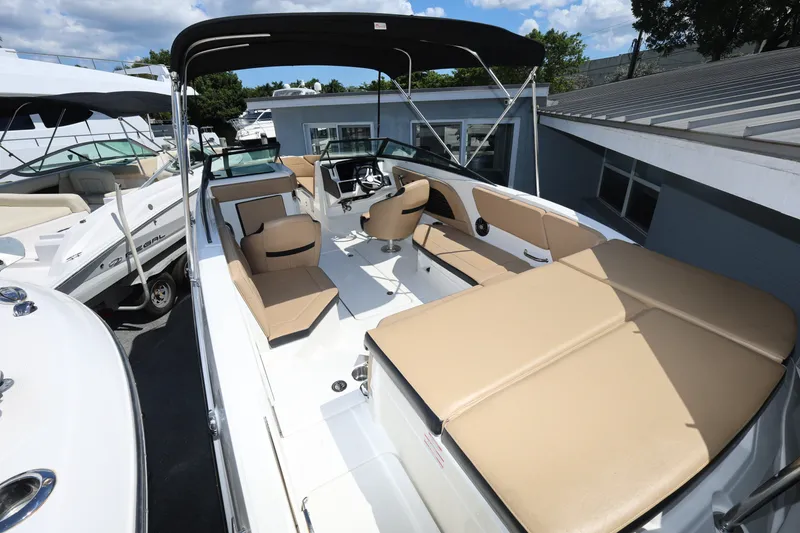 Slide: The Image of 2023 Sea Ray SPX 230 Outboard boat with beige seating and black canopy. - 8