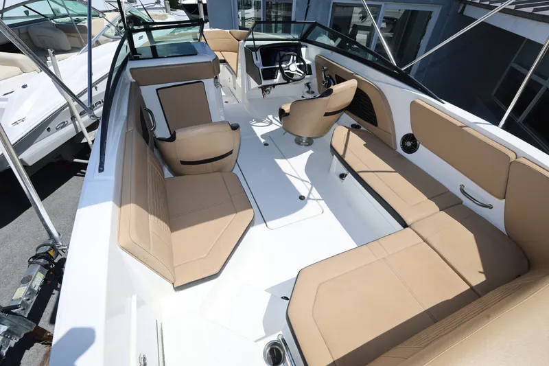 Slide: The Image of 2023 Sea Ray SPX 230 Outboard boat interior with tan seating and modern design. - 9