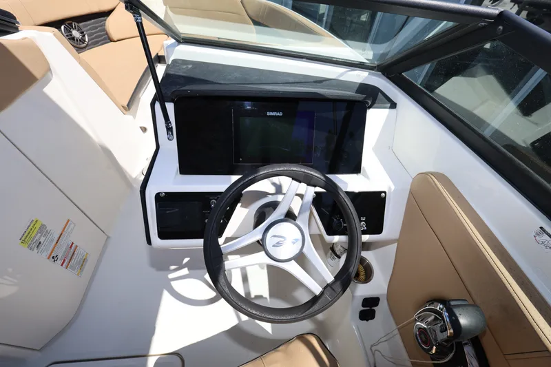 Slide: The Image of 2023 Sea Ray SPX 230 Outboard boat cockpit with steering wheel and control panel. - 13