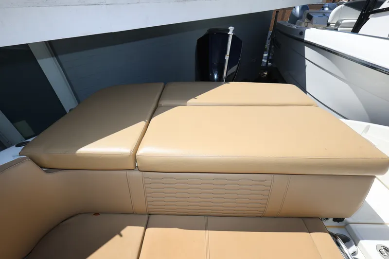 Slide: The Image of 2023 Sea Ray SPX 230 Outboard boat with tan cushioned seating. - 22