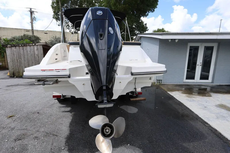 Slide: The Image of 2023 Sea Ray SPX 230 Outboard boat, rear view with outboard motor, parked outdoors. - 4